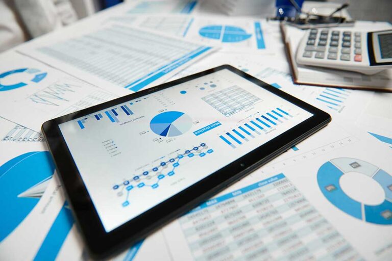 A household reviews tax forms, receipts, and home improvement documents at a kitchen table.